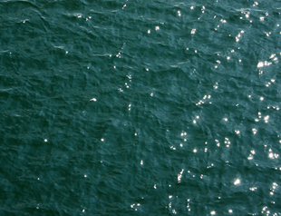 Aerial photo of open water with wave ripples