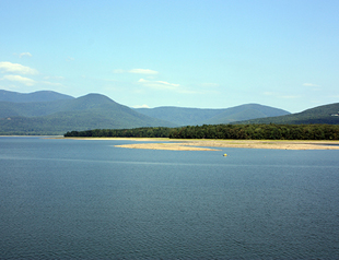 Photo of hills in the distance behind a body of water