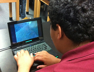 Photo of student playing the game on a laptop